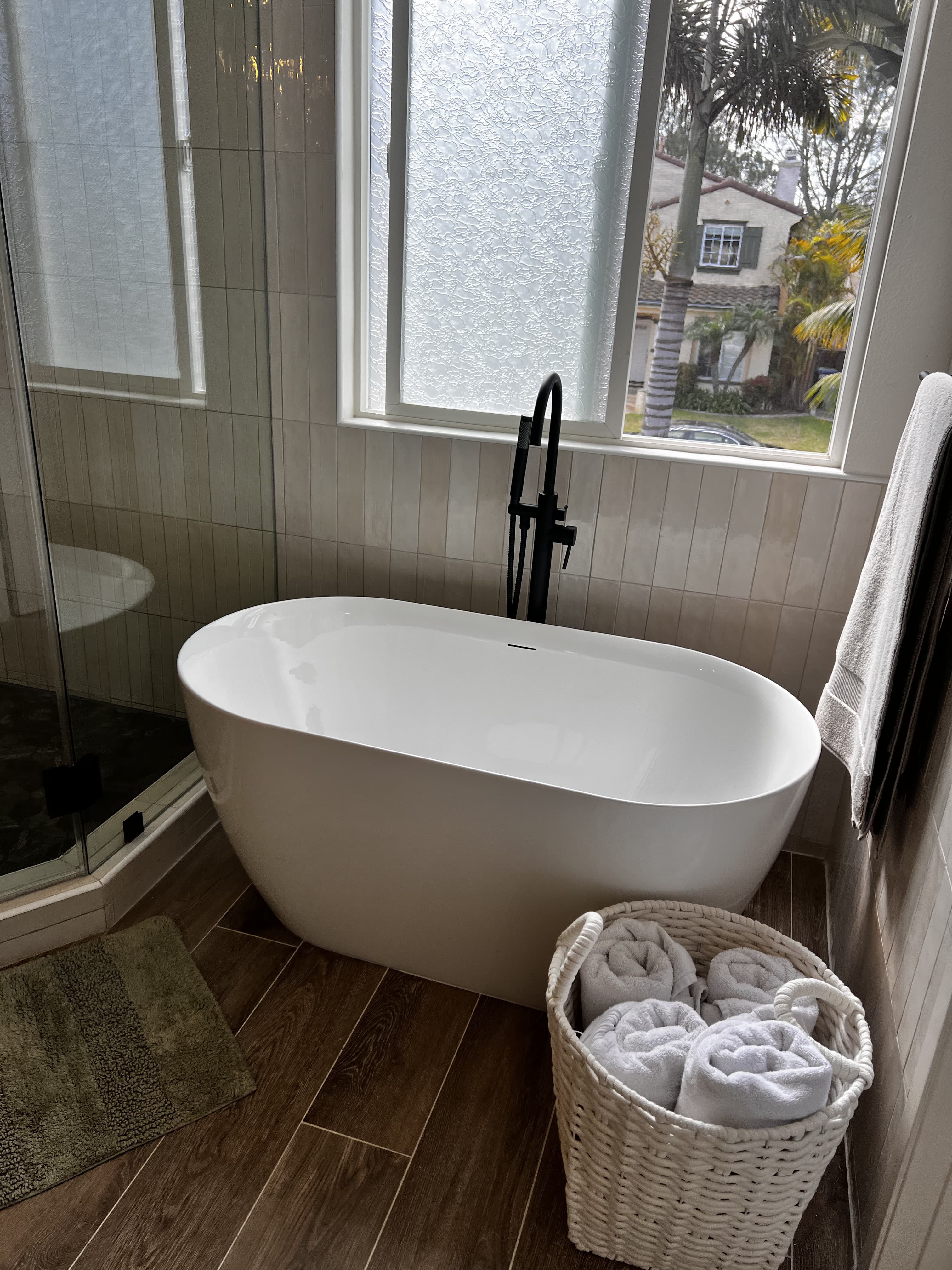 Freestanding tub bathroom with wood-look tile flooring